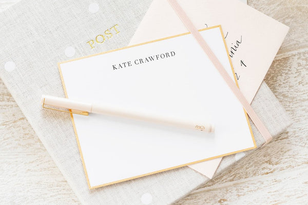 Personalized stationery with Kate crawford stacked on an address book with a pink pen