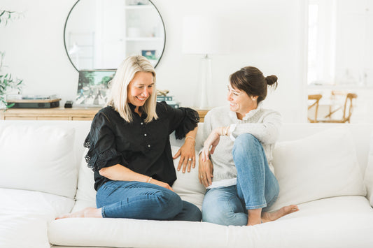sugar paper founders jamie grobecker and chelsea shukov on couch