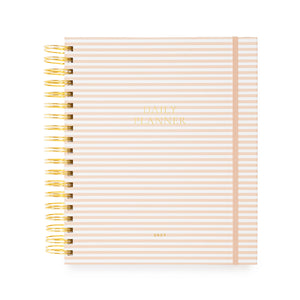Daily planner with pink and white stripes and a pink elastic with a gold coil spiral binding. Cover is stamped in gold foil with 'daily planner' and '2027'