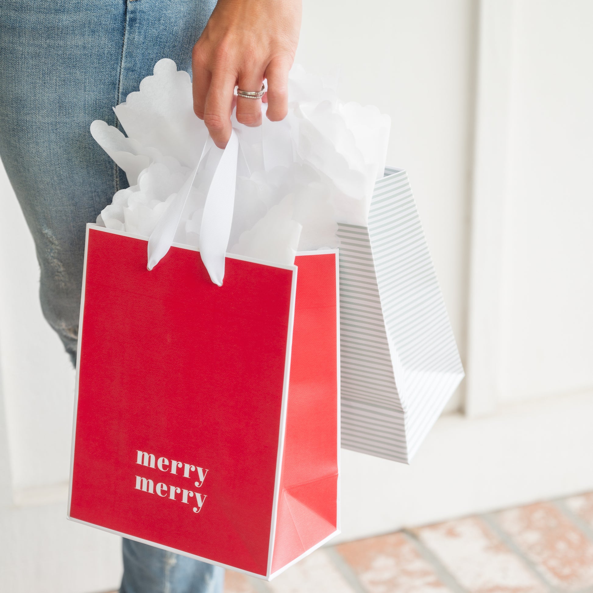 Holiday gift bags in hand