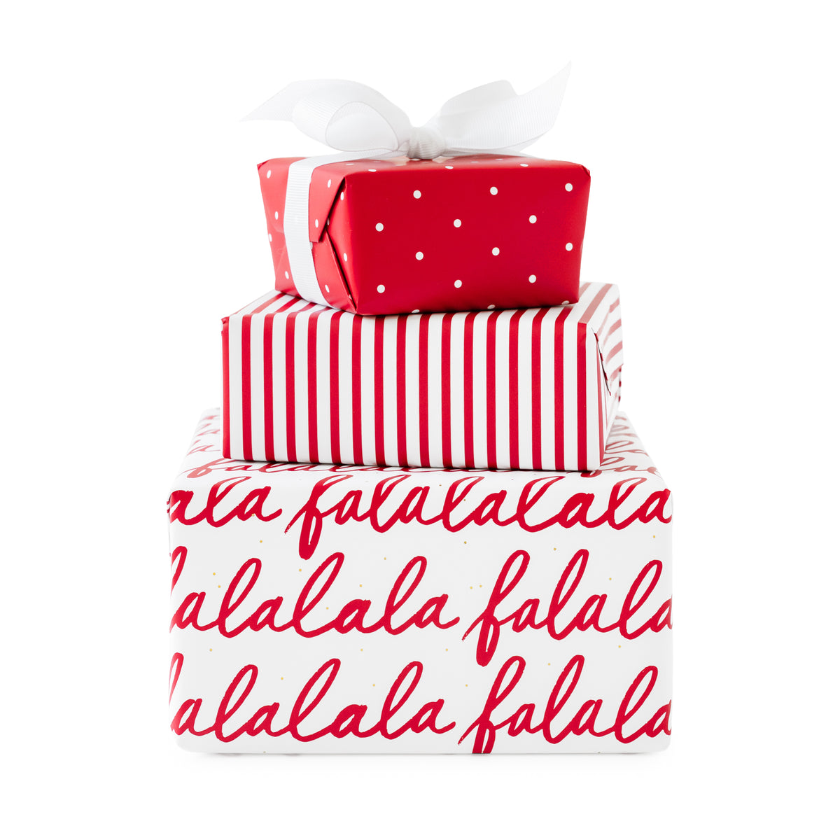 Stack of three wrapped gifts, bottom wrapped in white wrap with red falalala messaging, white with red stripes, and red with white swiss dot tied with a white bow on top