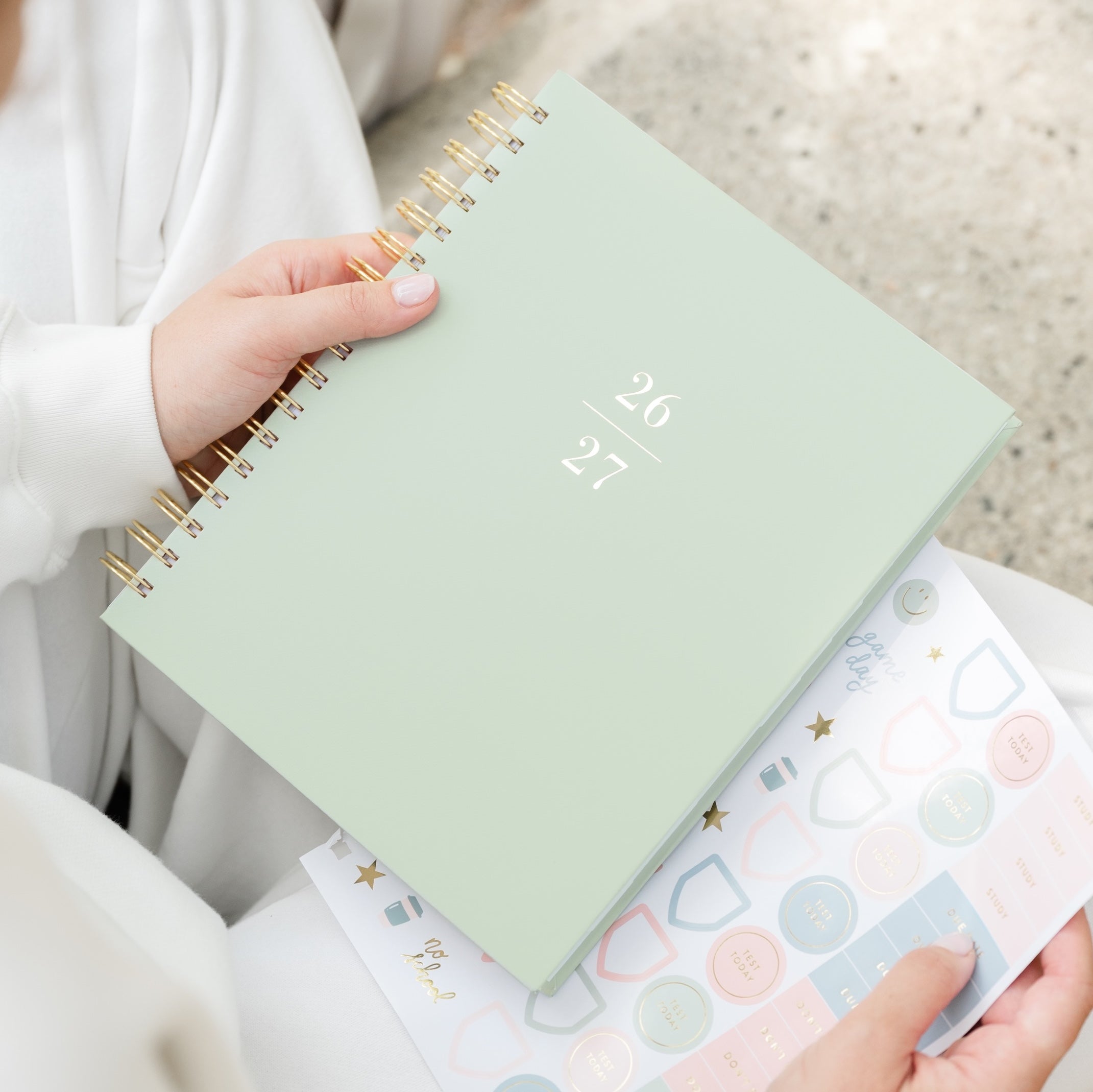 Office Green Spiral Planner with 26 27 on the cover