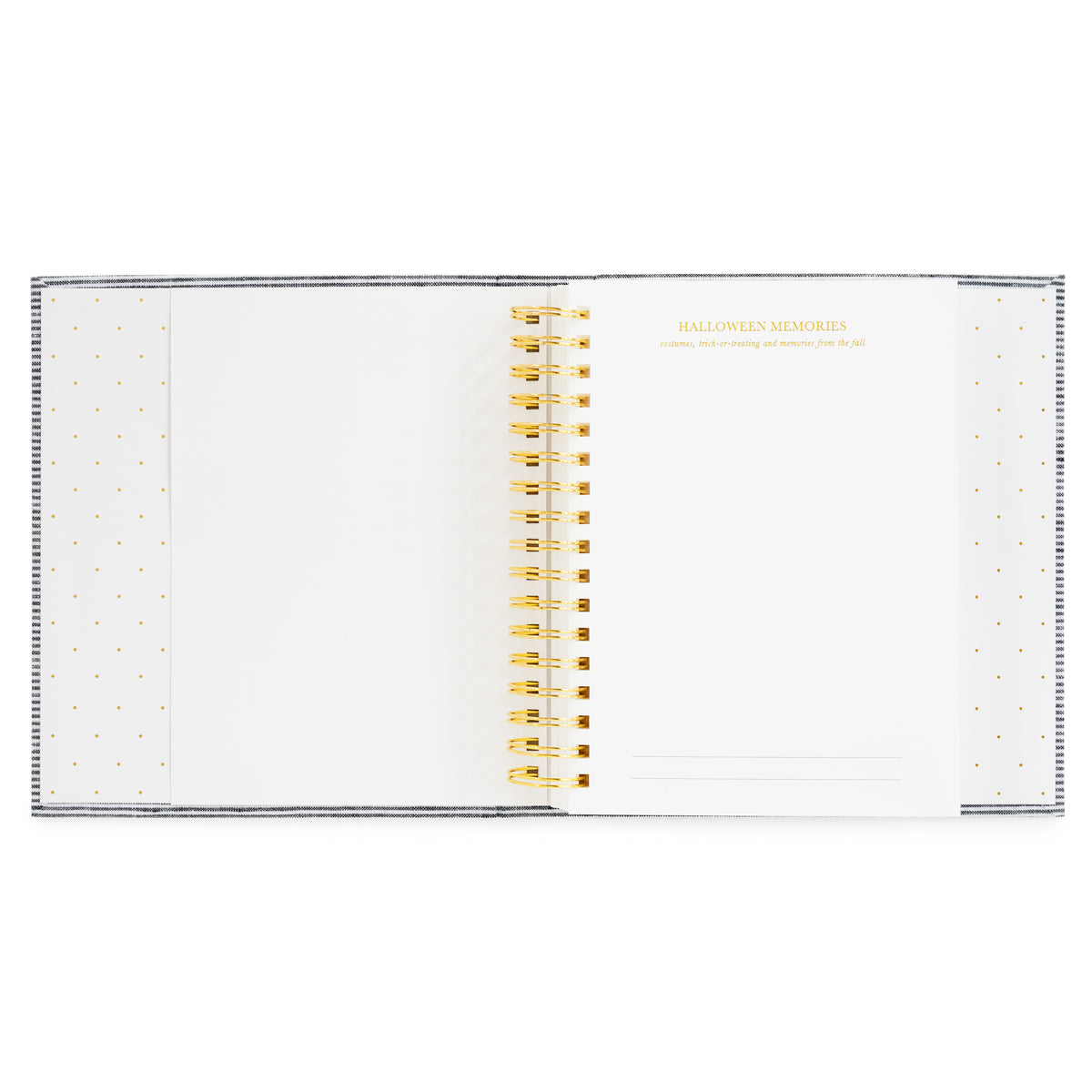 An open spiral-bound keepsake book with white pages, decorated with gold polka dots on the sides and gold text reading 'HALLOWEEN MEMORIES' on the right page. The pages are held together by a gold spiral coil.