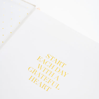 Motivational quote card with 'Start each day with a grateful heart' text in the fabric desk agenda