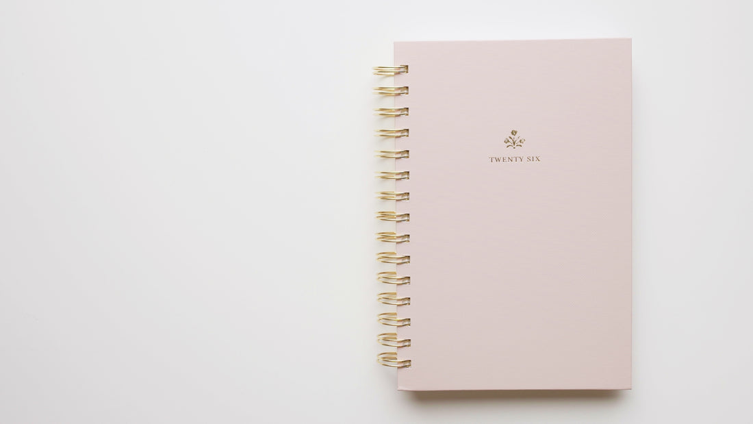 Interior of 2026 small pink spiral planner with gold spiral